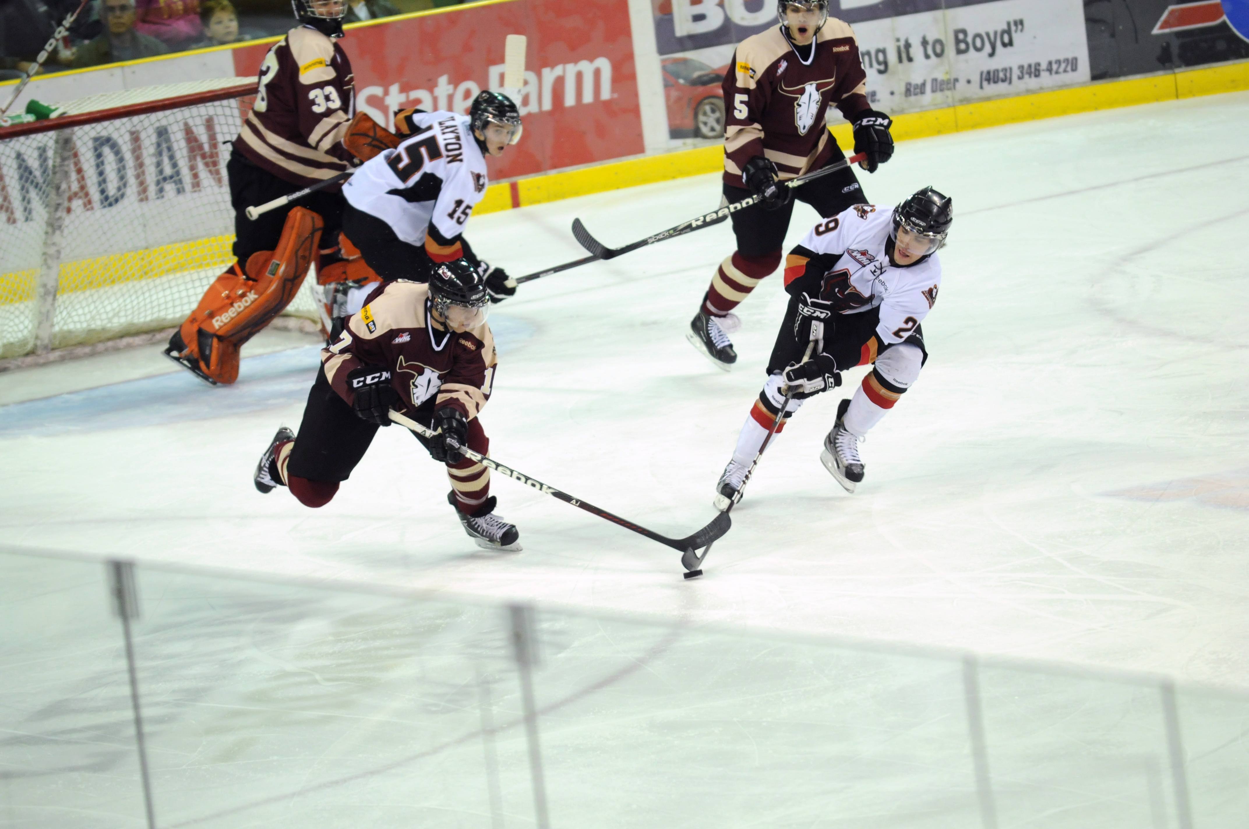 LOSING STREAK- Red Deer Rebel Chad Robinson tries to get the puck away from Calgary Hitmen Trevor Check during WHL action this past weekend. The Rebels lost 6-2.