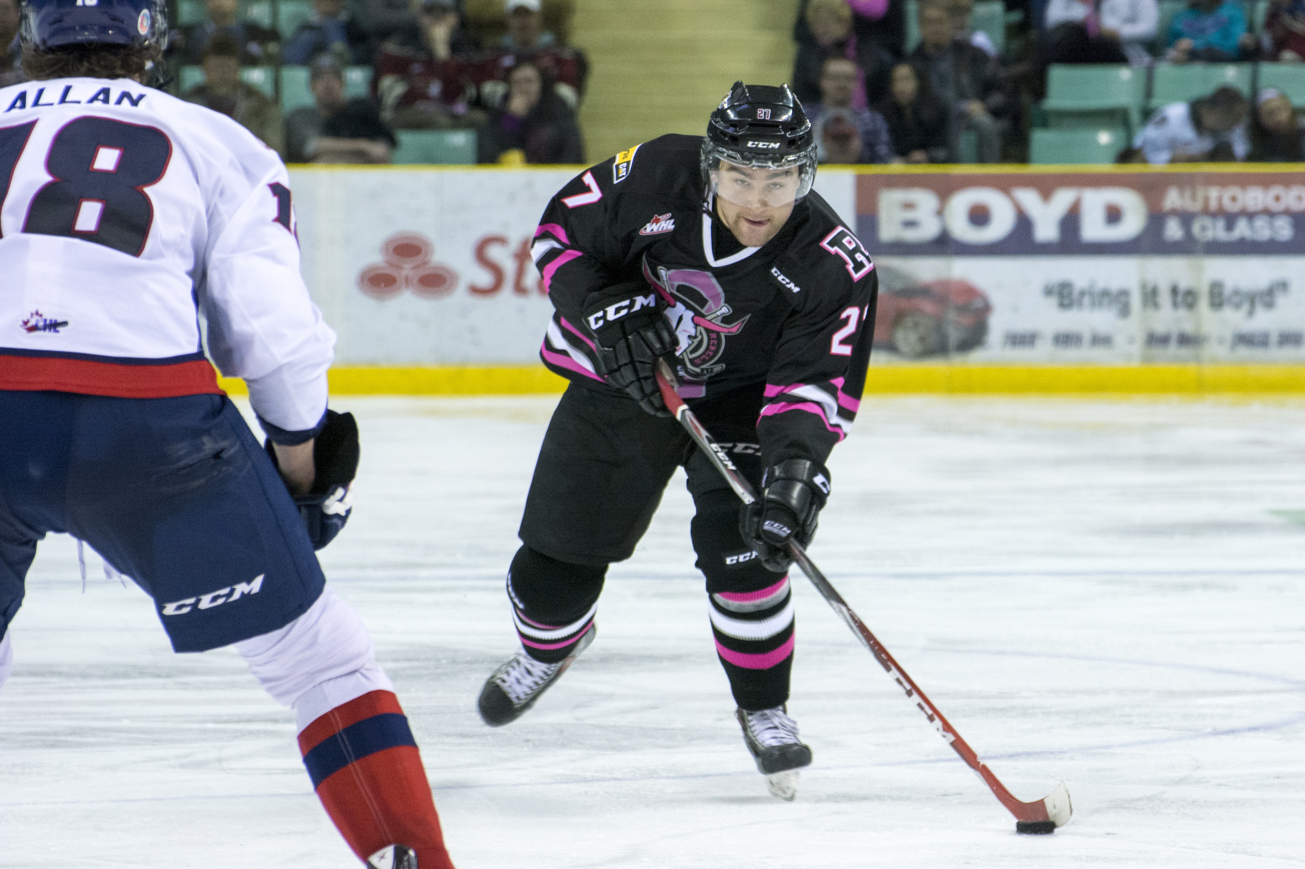 BIG DRIVE – Rebels defenseman Brett Cote makes a shot on goal during a game against the Lethbridge Hurricanes this past Saturday night at the Enmax Centrium. The Rebels dawned pink and black jerseys for the evening in support of breast cancer awareness.