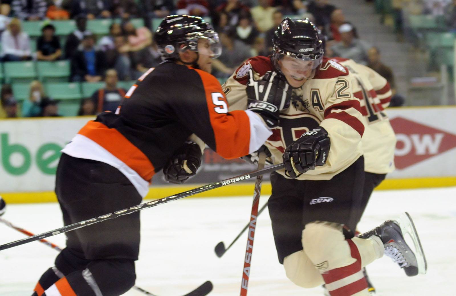 Red Deer Rebel Byron Froese gets pushed back by Medicine Hat Tiger Thomas Carr during WHL action Saturday night. The Rebels lost 4-1.