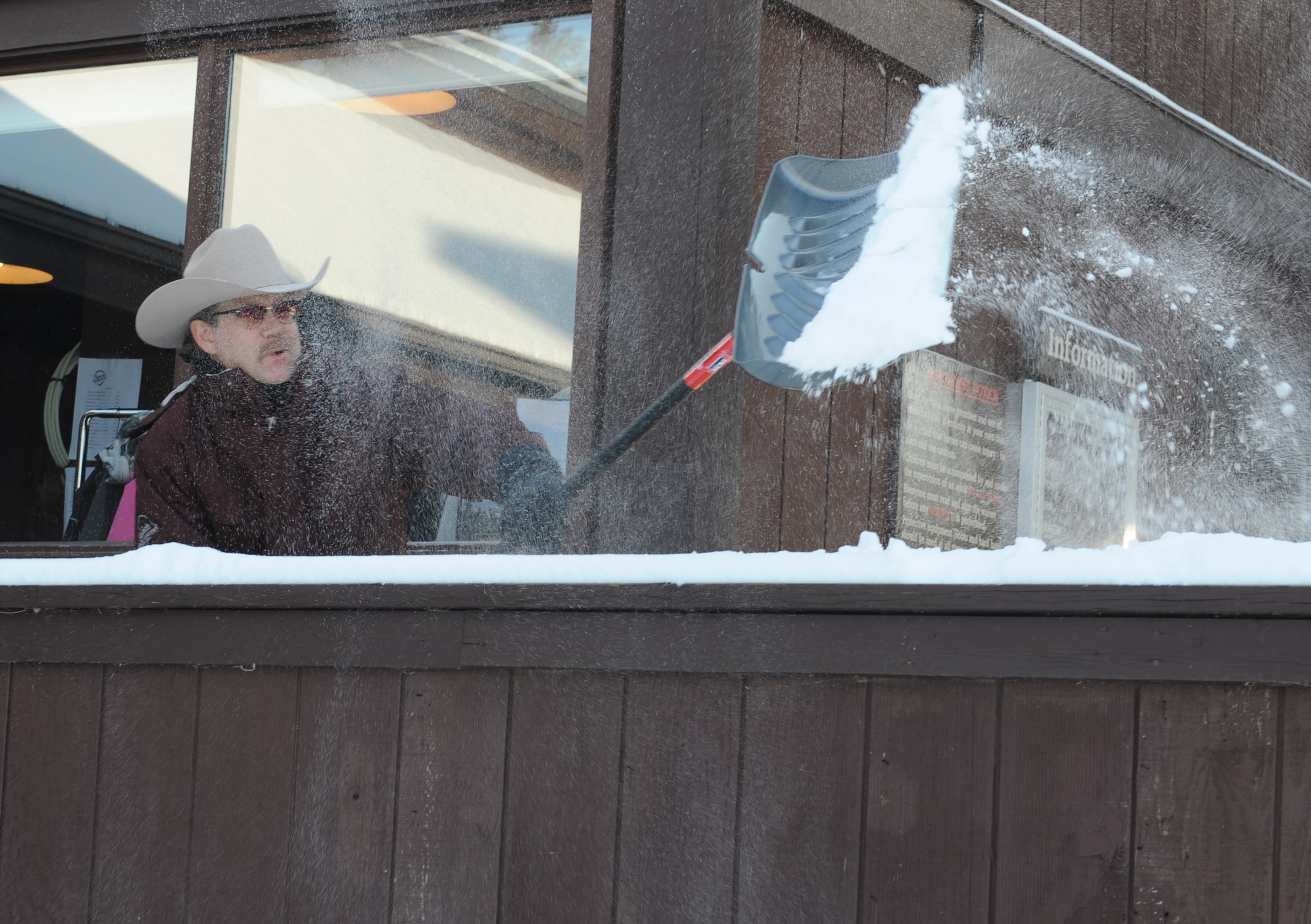 COLD SHOVELLING- Joel Martens clears the boardwalk around the Westlake Café this past weekend despite the chilling cold wind.