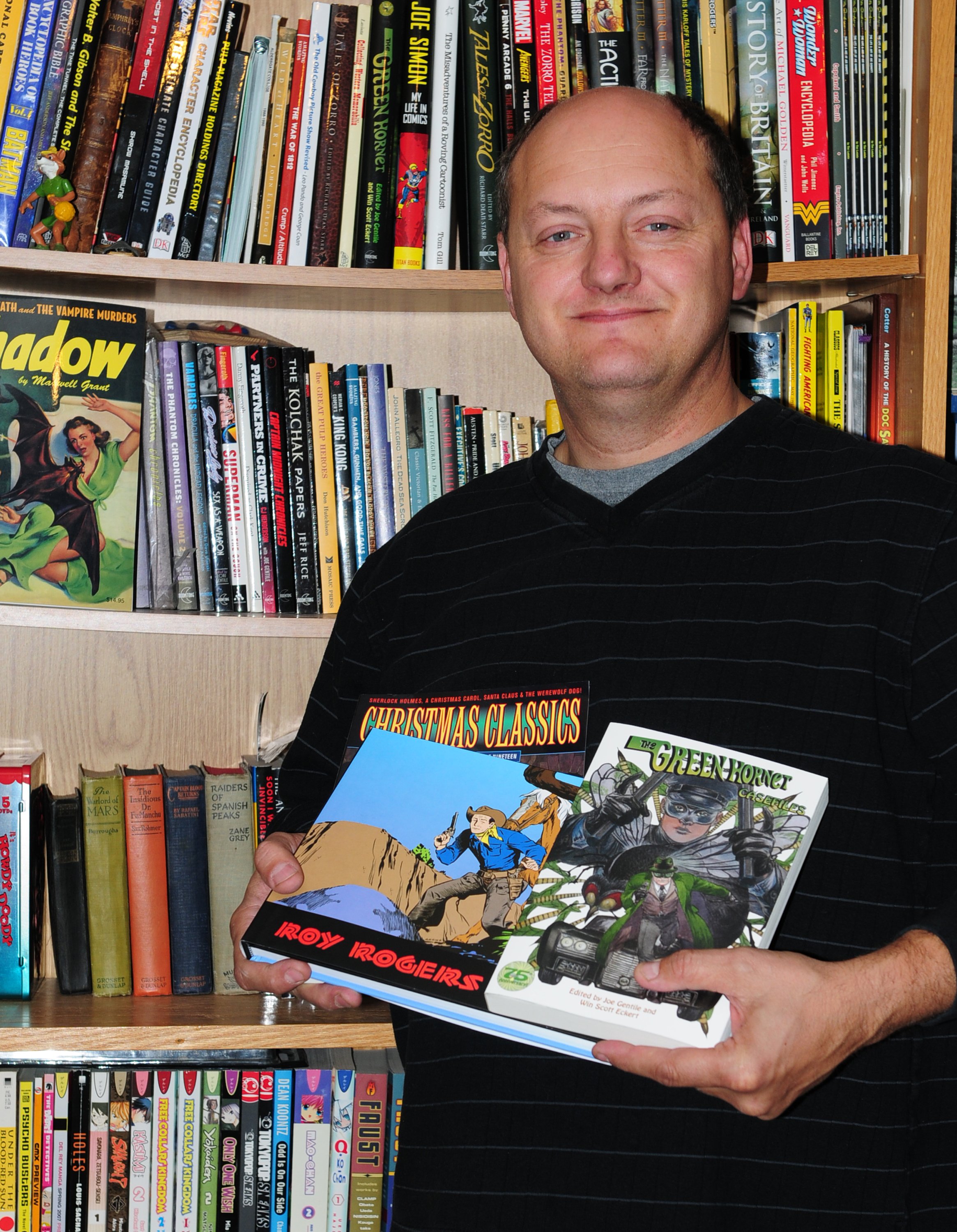 COLLECTION- Tim Lasiuta holds up a few of the comic books he contributed to over the years.