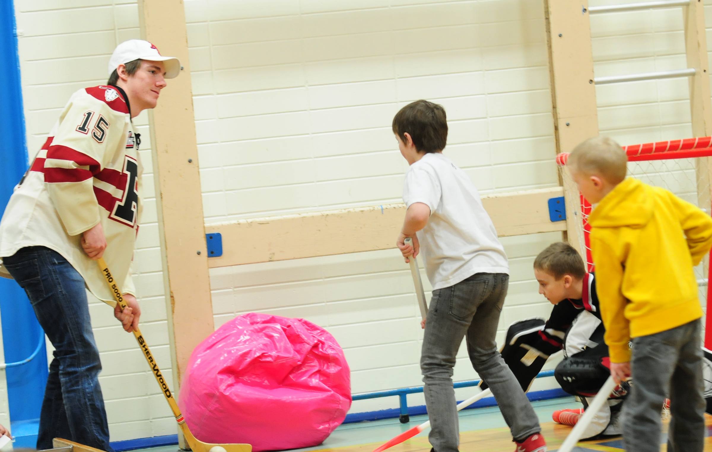 ROUGH GAME- Red Deer Rebel John Persson tries to get the ball away from G.W. Smith elementary students during the Rebels visit to the school Thursday afternoon.