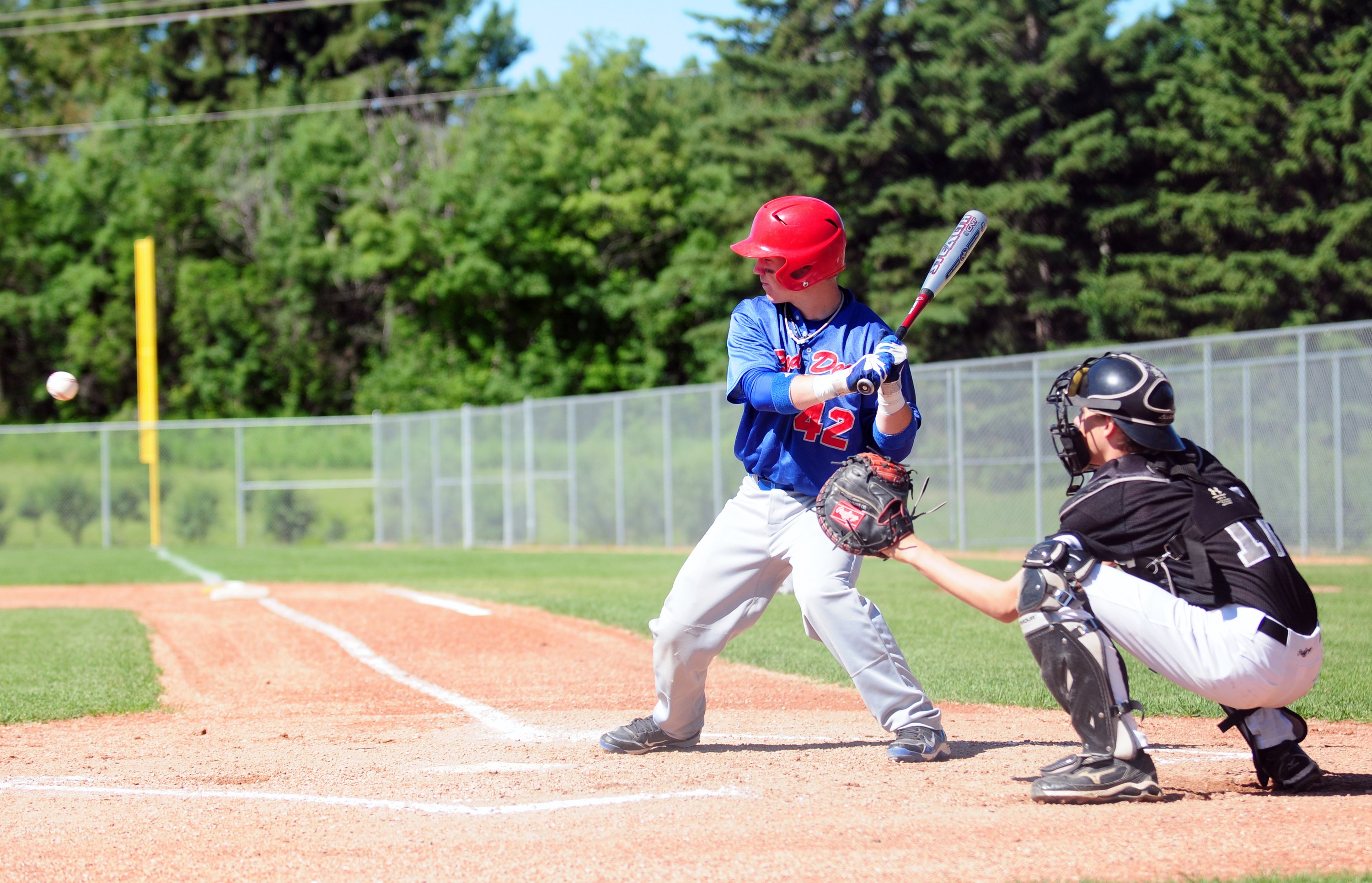 INCOMING- Red Deer Brave Riley Guntrip gets ready to swing as the pitcher throws the ball during minor baseball action this past weekend at Great Chief Park.