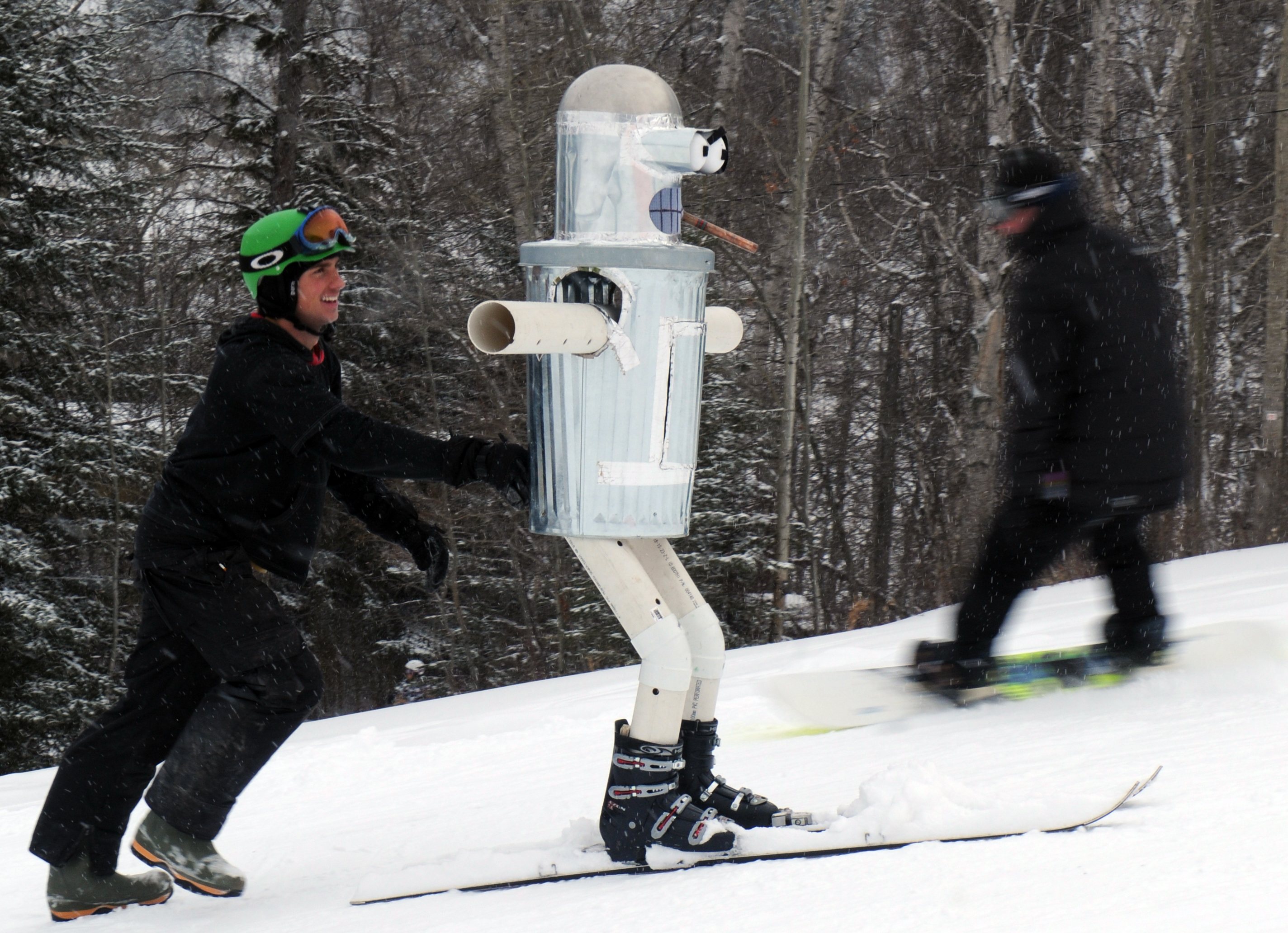 HEADING UP- Peter Martel pushes his entry for the dummy race up the hill during Canyon Ski Resort's Snow Fest this past weekend. Many events such as a scavenger hunt and races were only a few of the attractions this year.