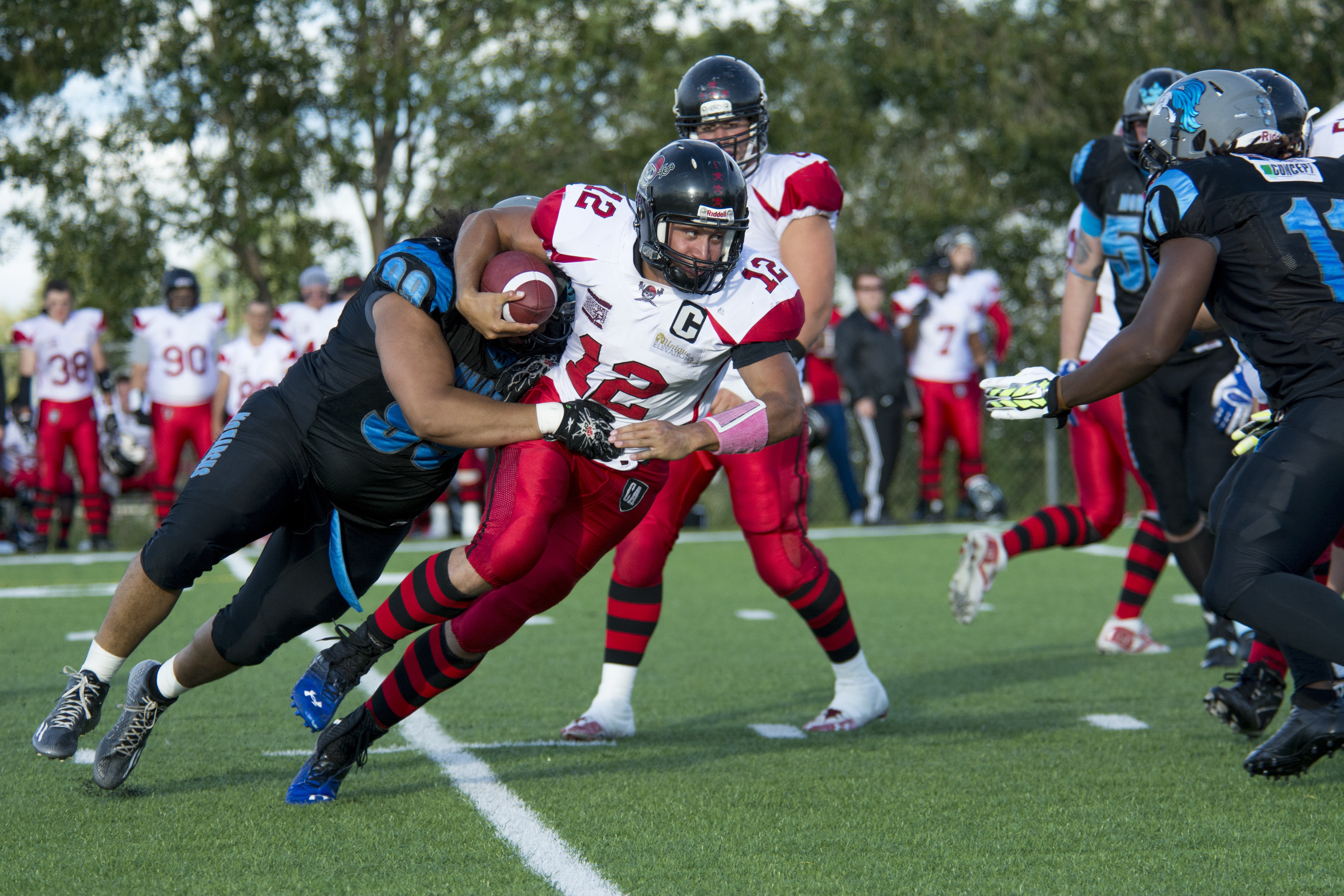 TOUGH GAME – Fort McMurray Monarchs defensive lineman Shaq Armstrong takes down Central Alberta Buccaneers quarterback Pascal Plante