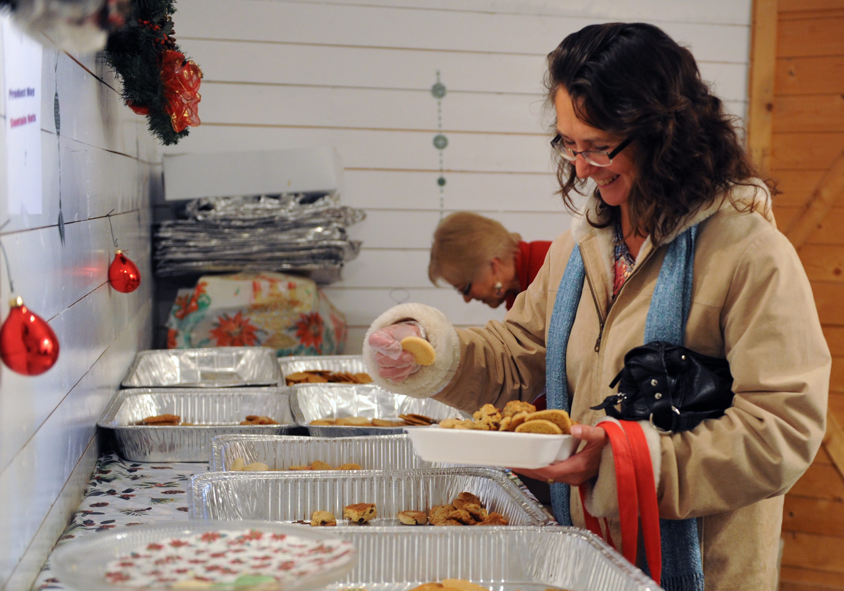 COOKIES- Barb Spruyt picks through a selection of cookies at the Cookie Walk in Markerville during Christmas in Markerville this past weekend.