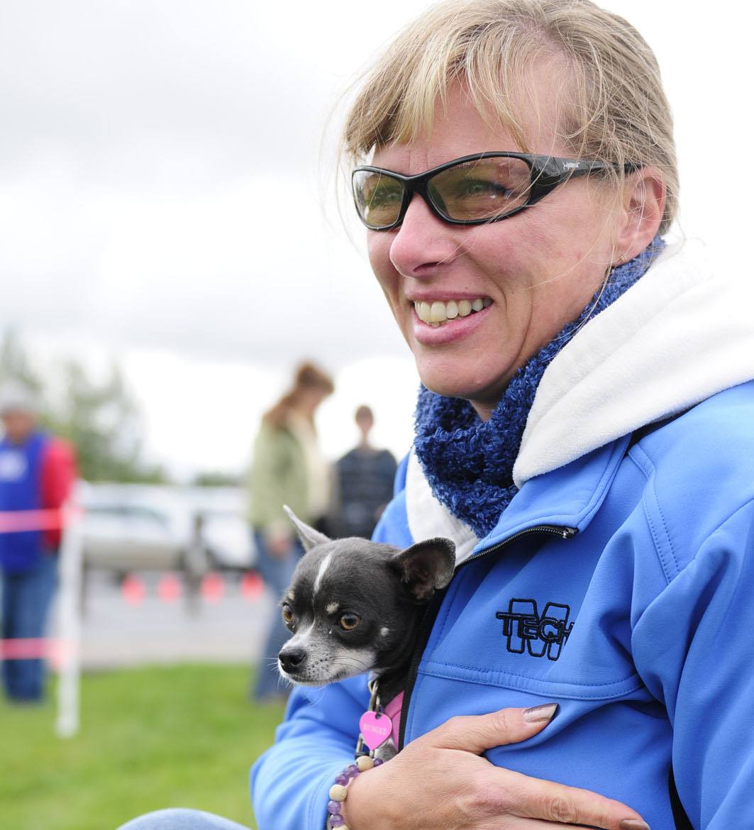 Sharna Mulligan keeps Bungee warm by holding him in her jacket at Three Mile Bend in Red Deer recently during an outing.