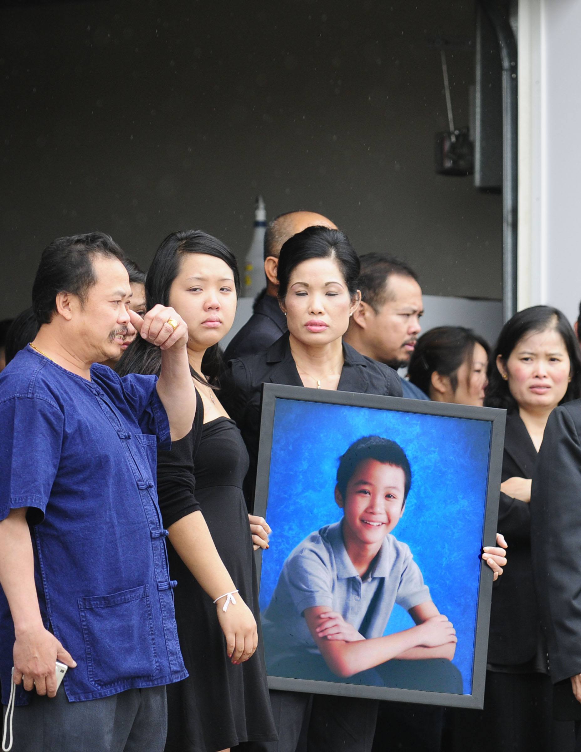 Family members of the late Anouluck 'Jeffrey' Chanminaraj outside the Parkland Funeral Home on July 10.