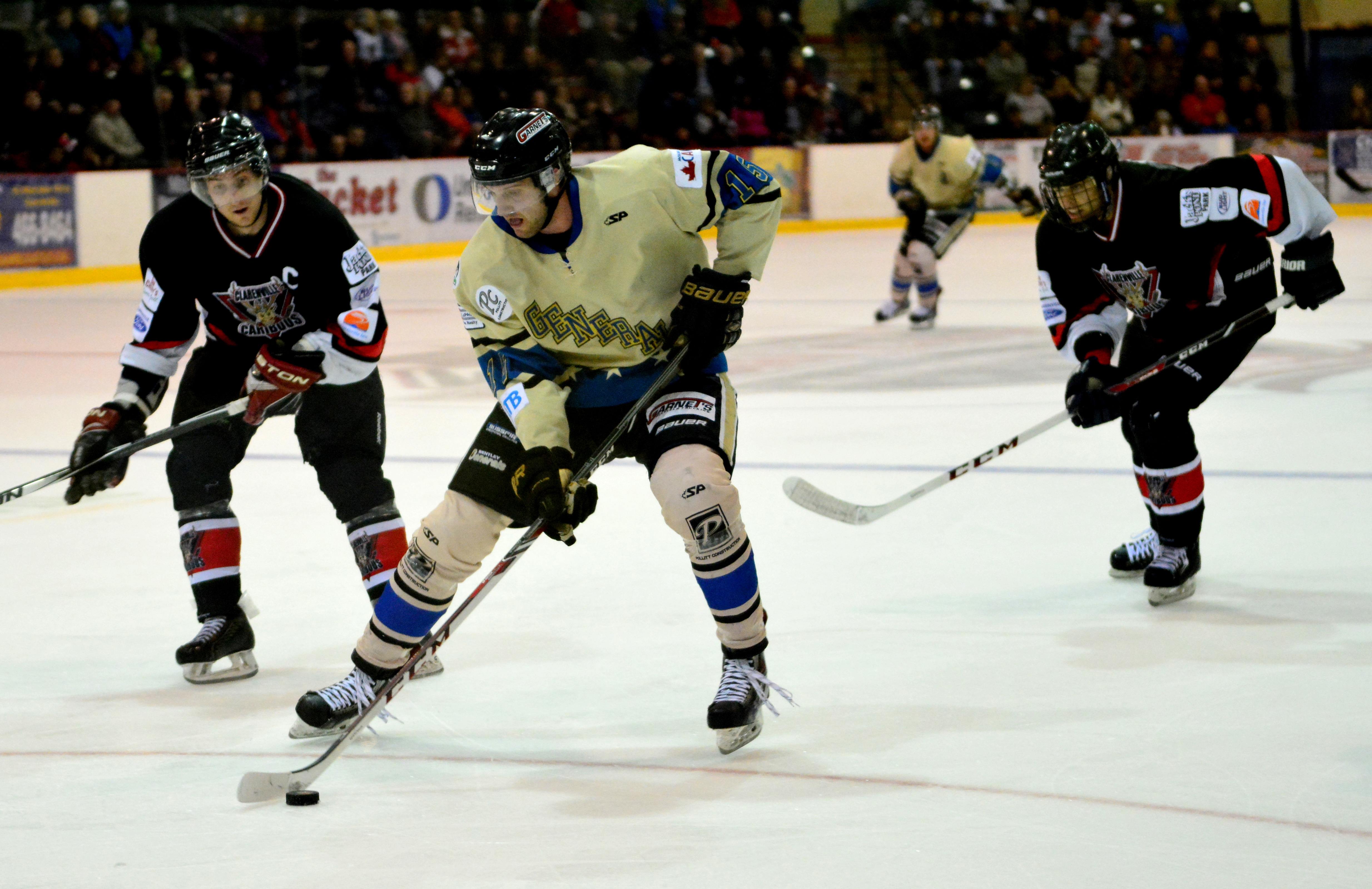 TOUGH LOSS - Bentley Generals forward Cam Maclise battled two Clarenville Caribou players during the 2015 Allan Cup championship. The Generals lost their chance at the championship title in the final game against the South East Prairie Thunder.