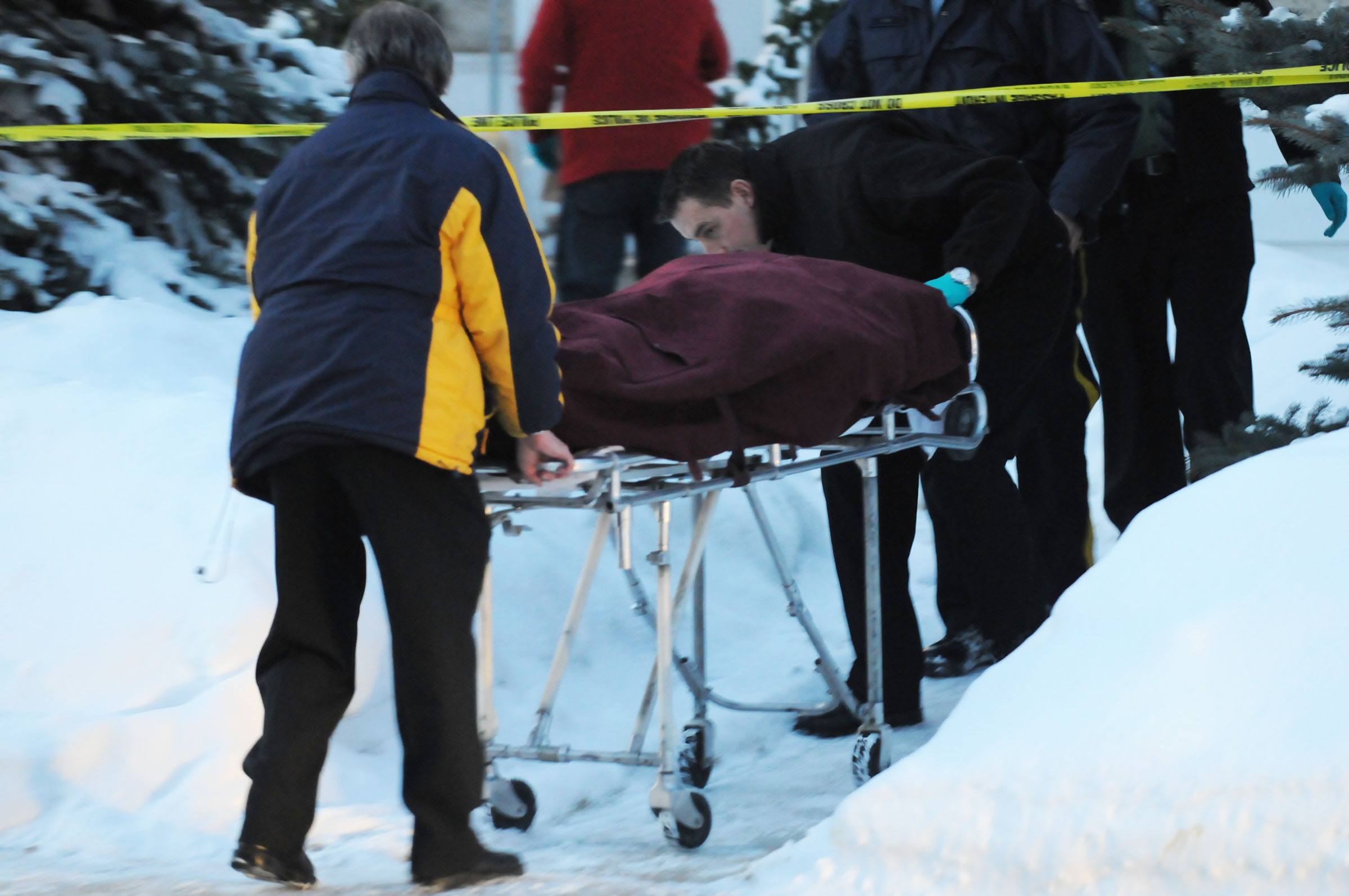 INVESTIGATION - RCMP members remove the body of a 40-year-old man who was found dead in a Fairview home early Thursday morning.