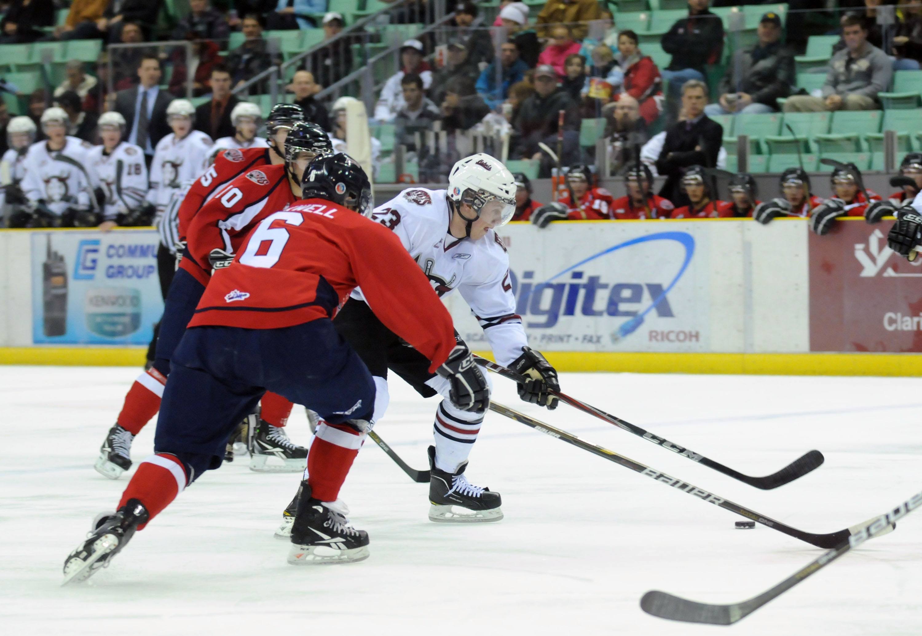 HOT PUCK- Red Deer Rebel Adam Kambeitz tries to get by members of the Lethbridge Hurricanes during WHL action Thursday evening. The Rebels won 5-0.