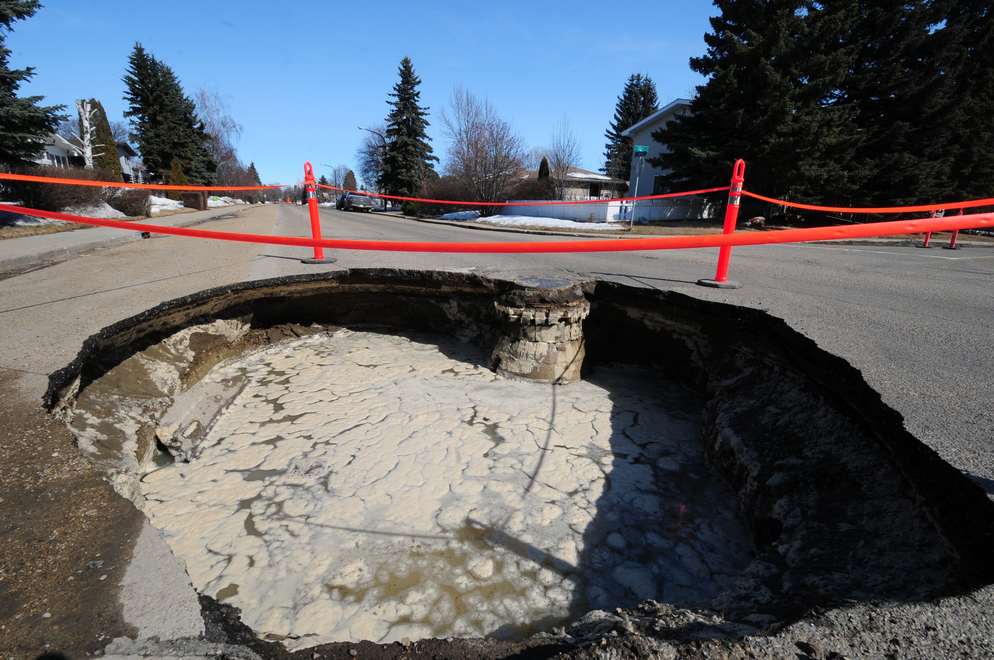 SINKING- CORRODED- A sinkhole that appeared at 43 Ave and 33 St. Wednesday morning had City workers busy cleaning up.