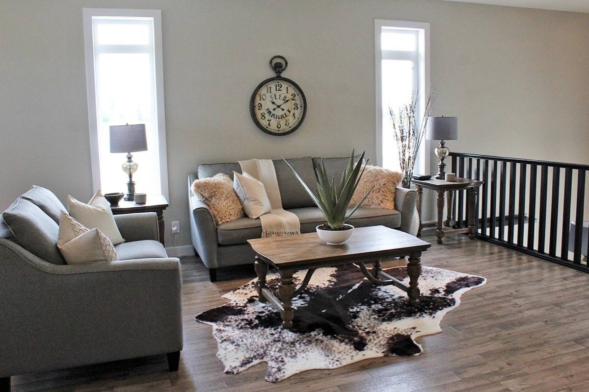UNWIND - A cozy and relaxing living room is part of this Laebon Homes show home on 17 Trebble Close. The home consists of three bedrooms and two bathrooms.                                Carlie Connolly/Red Deer Express