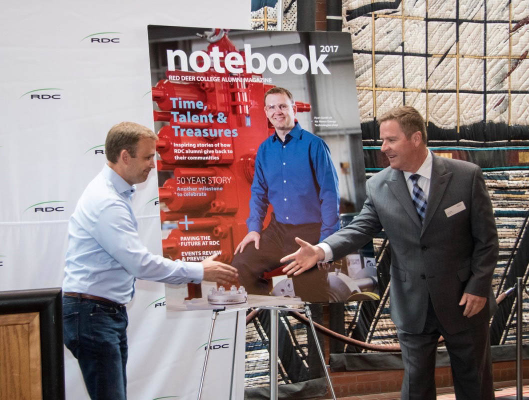 ALUMNI SUCCESS - Ryan Smith of Nexus Energy Technologies and RDC President Joel Ward helped unveil the 2017 Red Deer College Alumni Association’s publication the Notebook during an event at the Arts Centre Friday.                                Todd Colin Vaughan/Red Deer Express