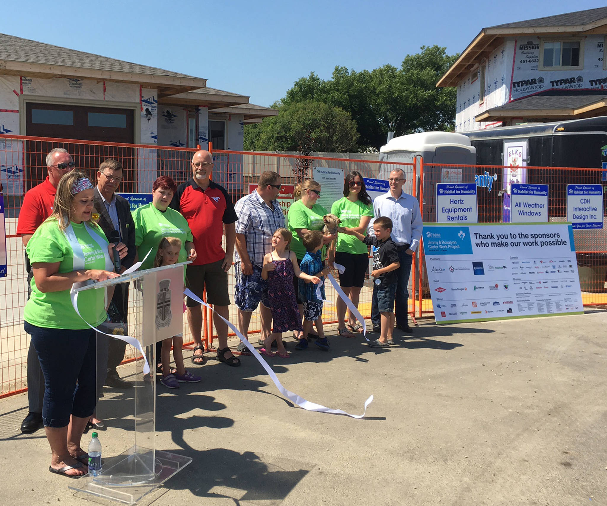 SPECIAL DAY - Jancee Hawthorne, one of the recipient families of a new Habitat for Humanity home in Lacombe, speaks during a key ceremony last week while other home recipients and officials with Habitat for Humanity look on. Mark Weber/Red Deer Express