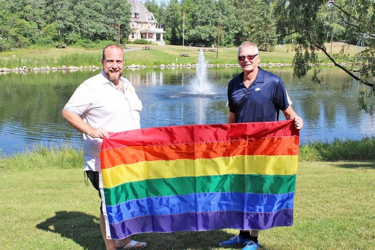 SHOWING PRIDE - Joel Graham and Serge Gingras of the Central Alberta Pride Society hold up a Pride flag at Bower Ponds where Pride Week celebrations will kick off on Aug. 13th. Carlie Connolly/Red Deer Express