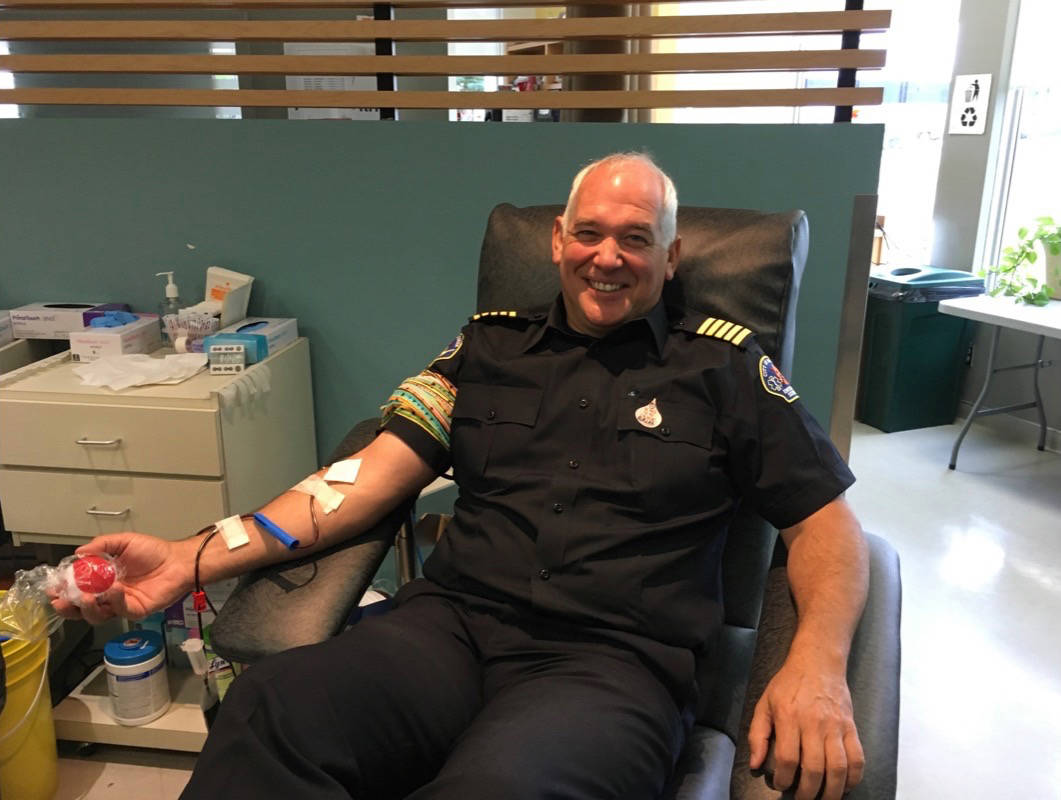 GIVING BACK - Red Deer Fire Chief Brian Makey donates blood for the first time as part of the Lifesaving Summer campaign via Canadian Blood Services. Erin Fawcett/Red Deer Express