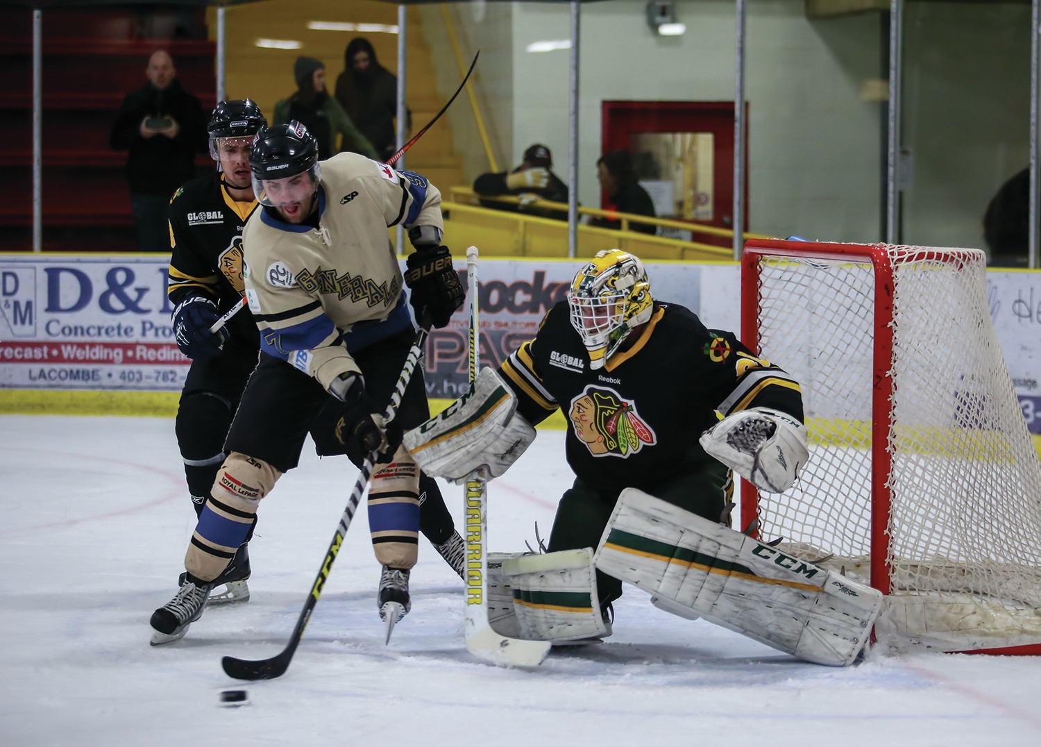 IMPRESSIVE DEBUT- From right, Ryan Demharter of the Ft. Saskatchewan Chiefs got into position as Jesse Todd of the Lacombe Generals stretched to reach a loose puck in front of the Chiefs’ net during the Generals’ home opener at the Gary Moe Auto Group Sportsplex in Lacombe this past Friday. The Generals came away with a 3-2 victory in the contest. Zachary Cormier/Red Deer Express