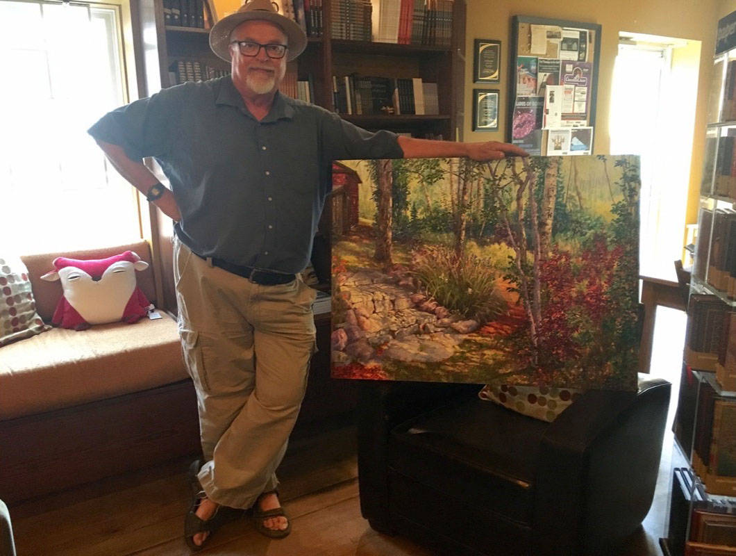 TALENTED FELLOW - Local artist Larry Reese poses with one of the works that is featured in a new exhibit at the White Gallery located in Sunworks in downtown Red Deer. Mark Weber/Red Deer Express
