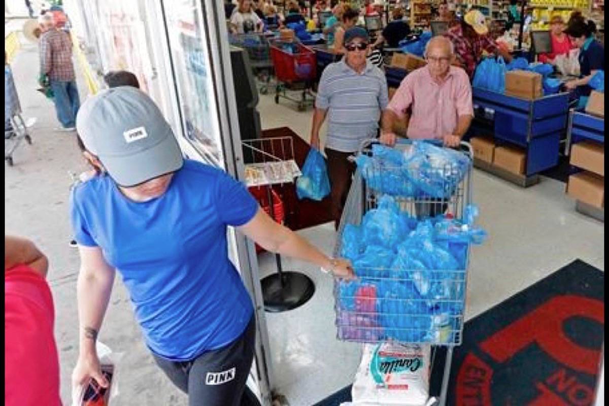 Customers purchase groceries at a local supermarket as they prepare for Hurricane Irma on Tuesday in Hialeah, Fla. Associated Press.