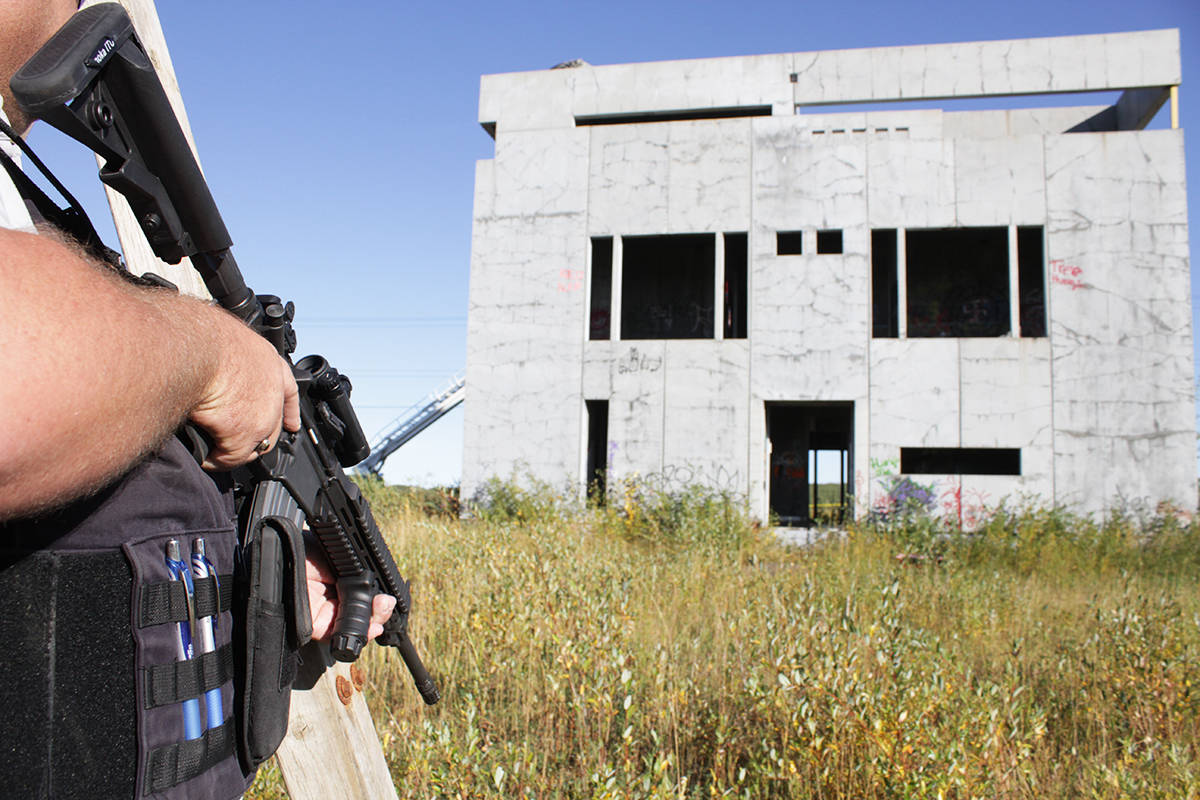 An RCMP member stands on watch while investigators enter the abandoned building to confirm there were no other individuals inside. There was no incident out of the building inspection. Photo by Jeffrey Heyden-Kaye