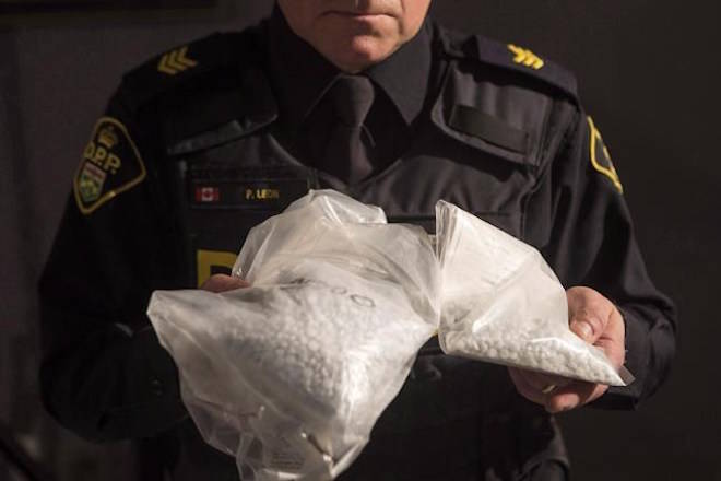 An OPP officer displays bags containing fentanyl as Ontario Provincial Police host a news conference in Vaughan, Ont., on February 23, 2017. File photo. THE CANADIAN PRESS/Chris Young