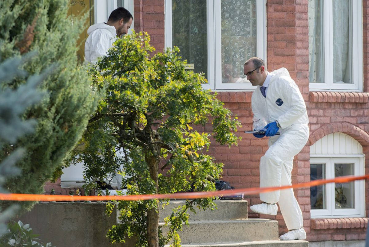 Police investigate a home in St-Eustache, Que., Friday, where the body of the mother of a boy who was the subject of an amber alert was found. The boy’s father, who was arrested in Ontario Friday, is in hospital after he became injured while in police custody Saturday. (GRAHAM HUGHES / THE CANADIAN PRESS)