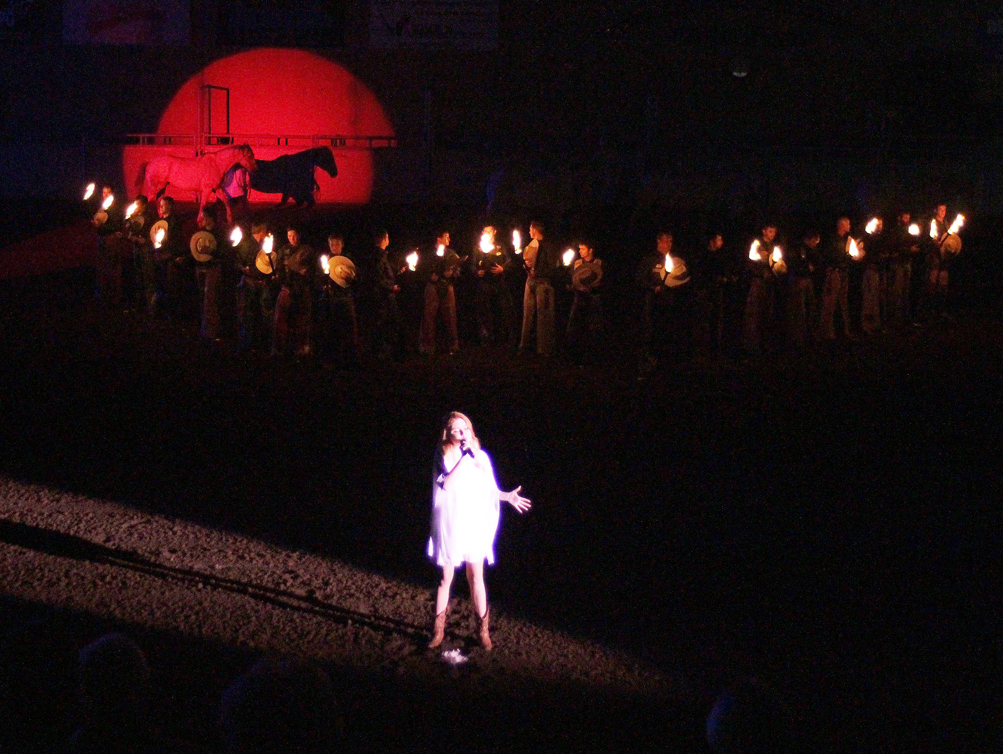 Cowboys celebrated the life of rodeo legend Winston Bruce Sept. 19 at the Calnash Ag Event Centre in Ponoka. As part of his celebration cowboys with lit torches honour Bruce while Caitlin Herring sings 7 Spanish Angels. There was standing room only. Photos by Jeffrey Heyden-Kaye