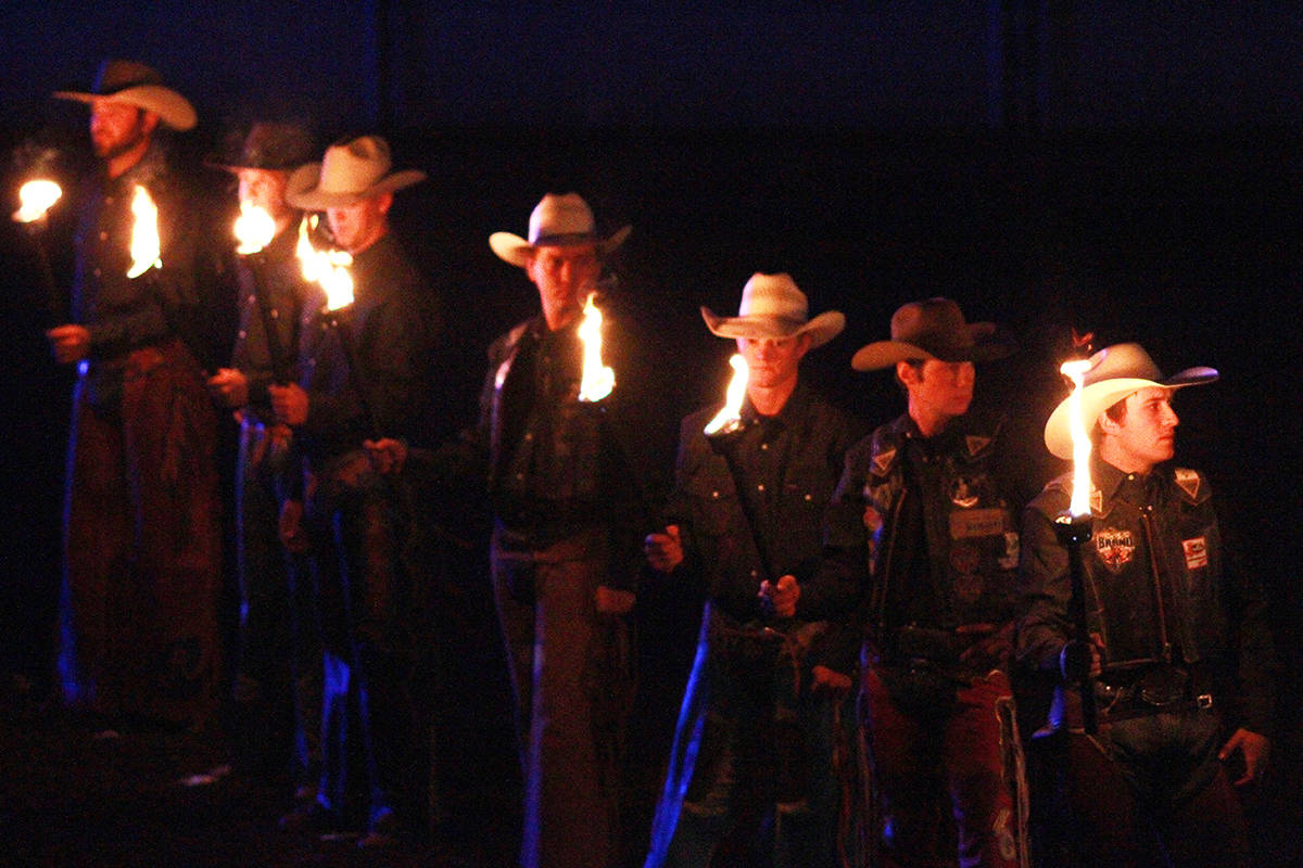 Cowboys stand with lit torches Sept. 19 at the Calnash Ag Event Centre in Ponoka for the celebration of life of rodeo legend Winston Bruce who passed away July 10. Photos by Jeffrey Heyden-Kaye