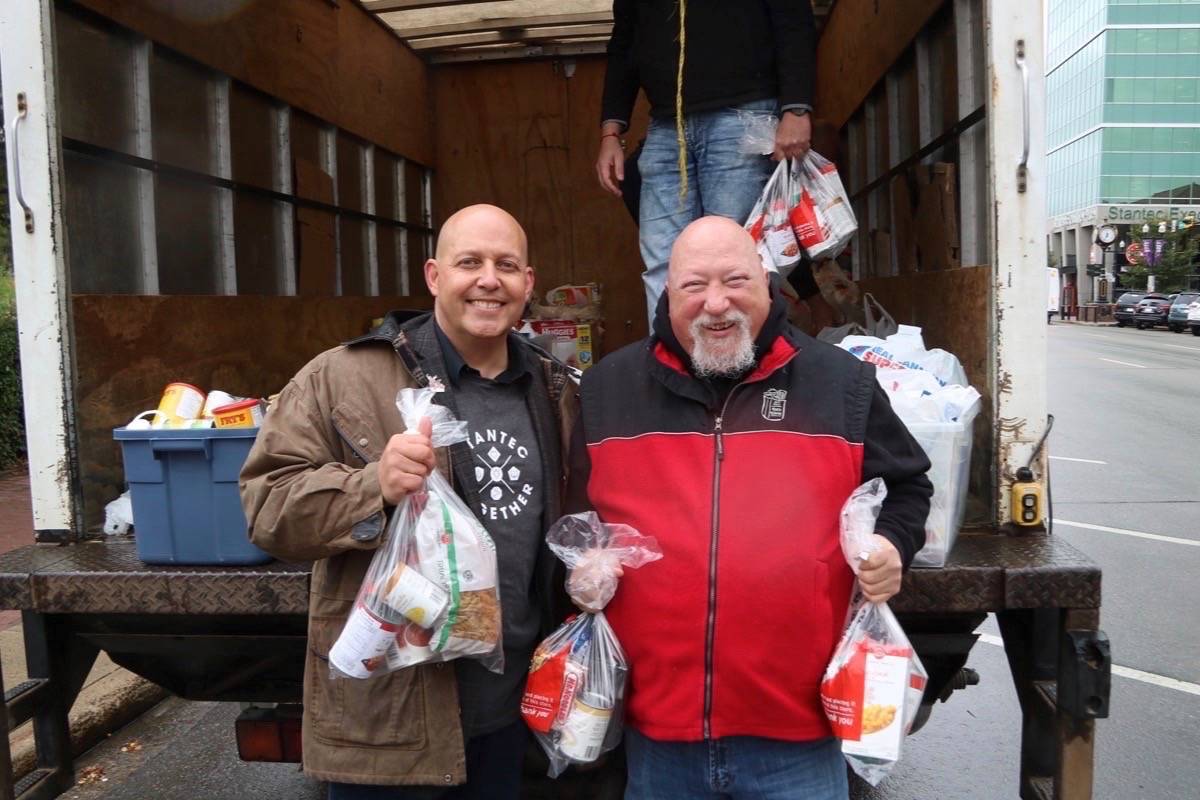 FOOD DRIVE - Stantec Vice President Todd Simonsen and Executive Director Fred Scaife of the Red Deer Food Bank helped load the truck at Stantec’s Feed the Need Food Drive and BBQ last week. Todd Colin Vaughan/Red Deer Express