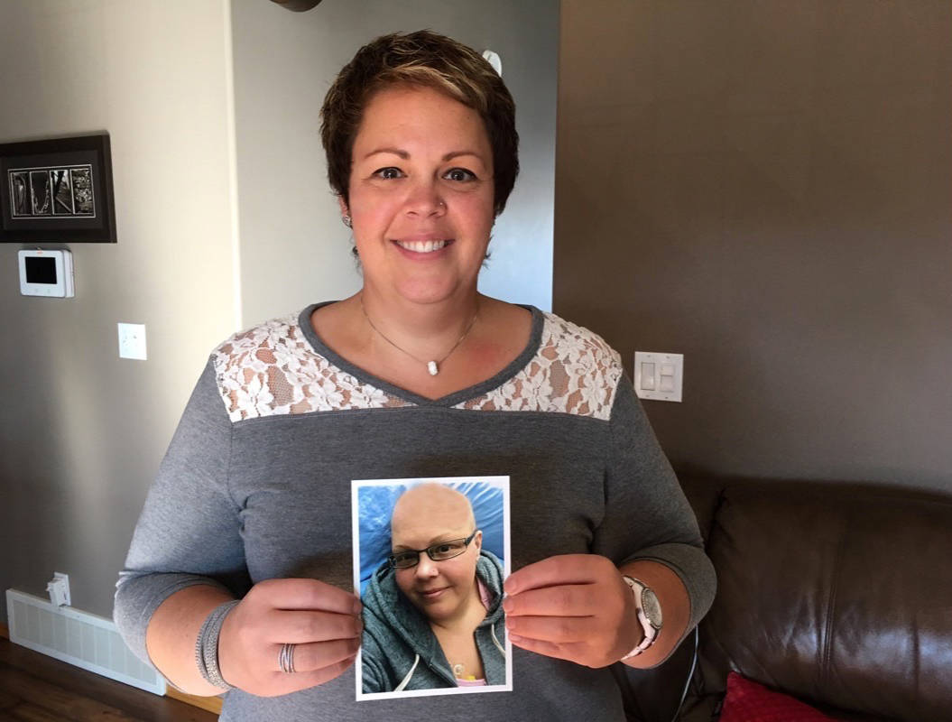 SURVIVOR - Lisa Duke holds a photo of herself as she was undergoing treatment for breast cancer. Duke is now cancer free. She hopes to use her story to inspire other women. Erin Fawcett/Red Deer Express