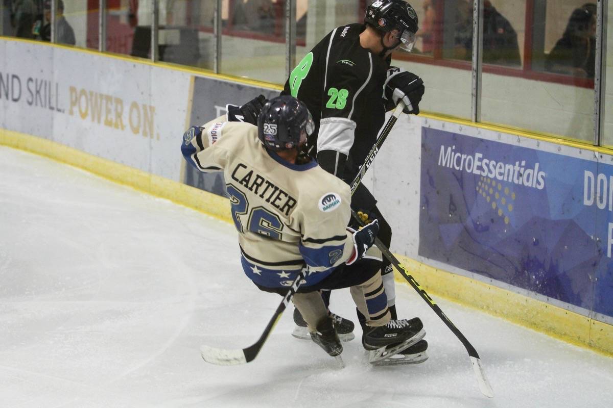 GENERALS HOCKEY - Generals forward Cody Cartier took a hit from Red Deer College King Trevor Costello. The Generals would go on to lose the exhibition showdown held Sept. 29th with a score of 5-4. Todd Colin Vaughan/Red Deer Express
