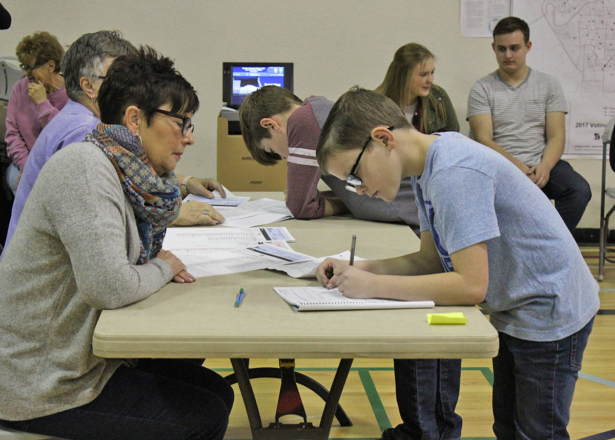 STUDENT VOTE - Grade 6 student Roman White fills out some information at a trial election held at Central Middle School. Carlie Connolly/Red Deer Express