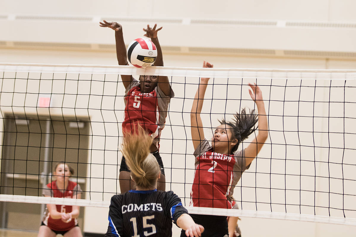 HOME OPENER - St. Joseph High School Falcons Neema Leon and Camille Manuel went up for the big block during the very first tournament held at the new Catholic high school last week. Todd Colin Vaughan/Red Deer Express