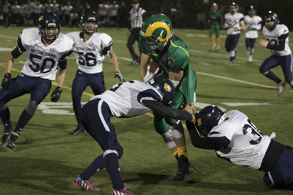RAMS WIN - Lacombe Ram Richard Jans powered in through two Notre Dame Cougars enroute to a 43-28 victory. The Rams will play the Hunting Hills Lightning next week for the league championship. Todd Colin Vaughan/Red Deer Express