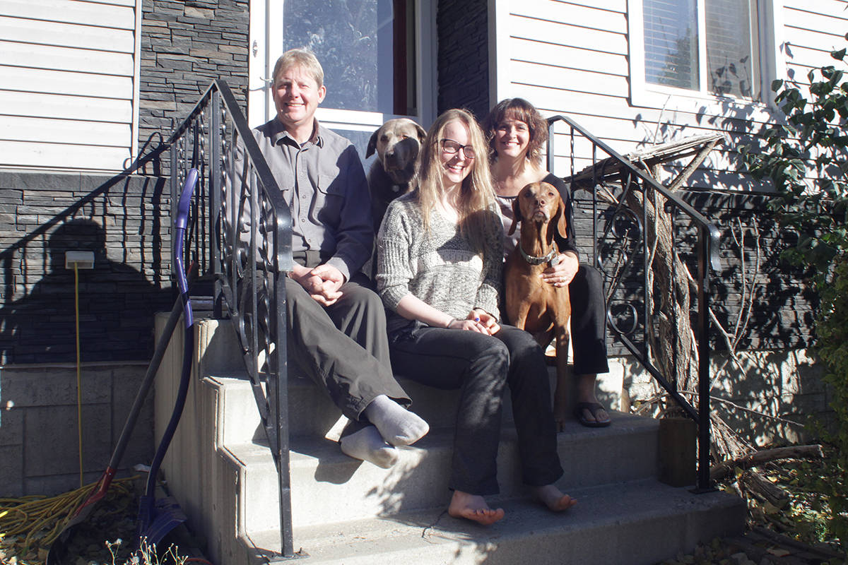 Amanda Burt, 19, sits with her parents, Randy and Nicole, at their home in Lacombe. Amanda recounts how a collision changed her life forever and yet she has seen remarkable recovery.                                Photo by Jeffrey Heyden-Kaye