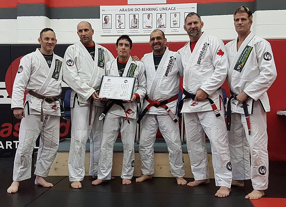 PROUD MOMENT - Ryan Williams holds his certificate at Arashi-Do Martial Arts where he received his black belt from Mestre (Master) Sylvio Behring.                                photo by Stephanie Essensa