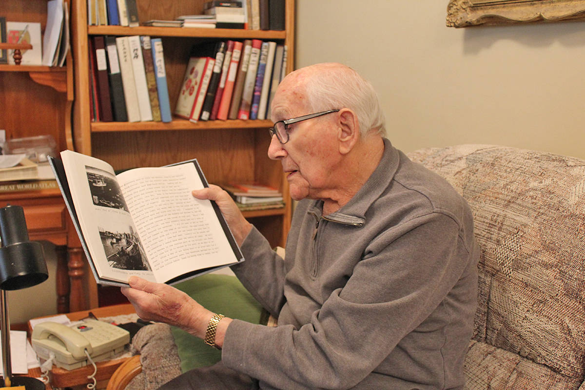 A SAILOR’S LIFE - Tom Pyper flips through the book he wrote years ago on the reflection of what he saw after the Second World War.                                Carlie Connolly/Red Deer Express