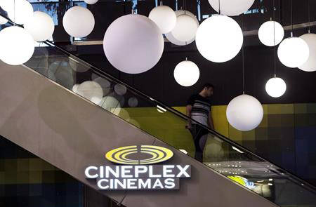 A man makes his way down an escalator during the Cineplex Entertainment company’s annual general meeting in Toronto on May 17, 2017. (Nathan Denette/The Canadian Press)