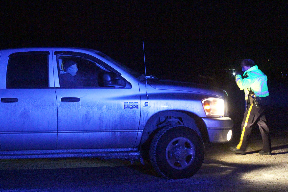 Ponoka RCMP check vehicles and speak with motorists Nov. 6 just east of town as Mounties look for a man involved in a carjacking earlier in the day.