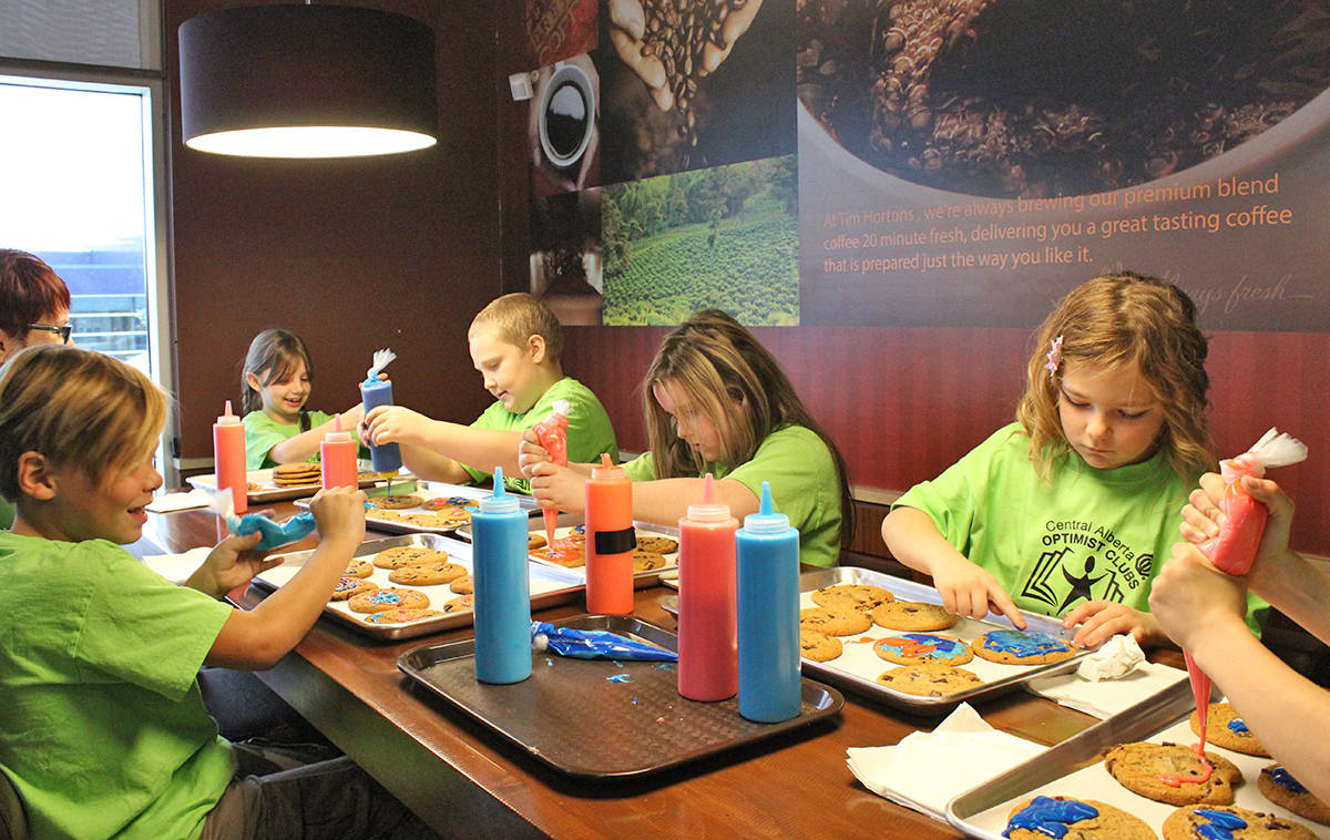 SMILES ALL AROUND - Students of the Reading College program got to decorate some more Smile Cookies in today’s announcement of the almost $34,000 raised from the Tim Hortons Smile Cookie Campaign. Carlie Connolly/Red Deer Express