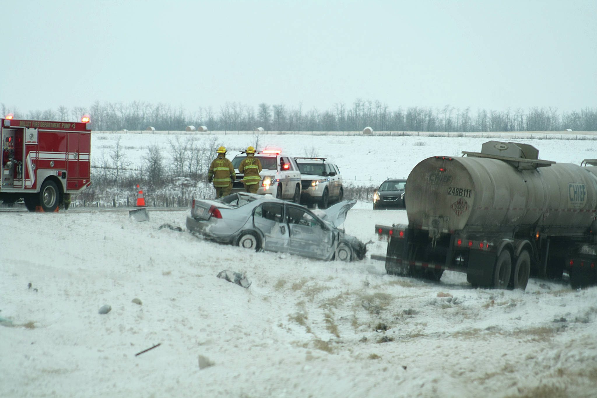 First responders on scene at a motor vehicle accident, Nov. 15. Both a semi truck and a car sit in the meridian between the north and south lanes of traffic along Highway 2, south of Secondary Highway 616 and southwest of the Town of Millet. Photo by Amelia Naismith