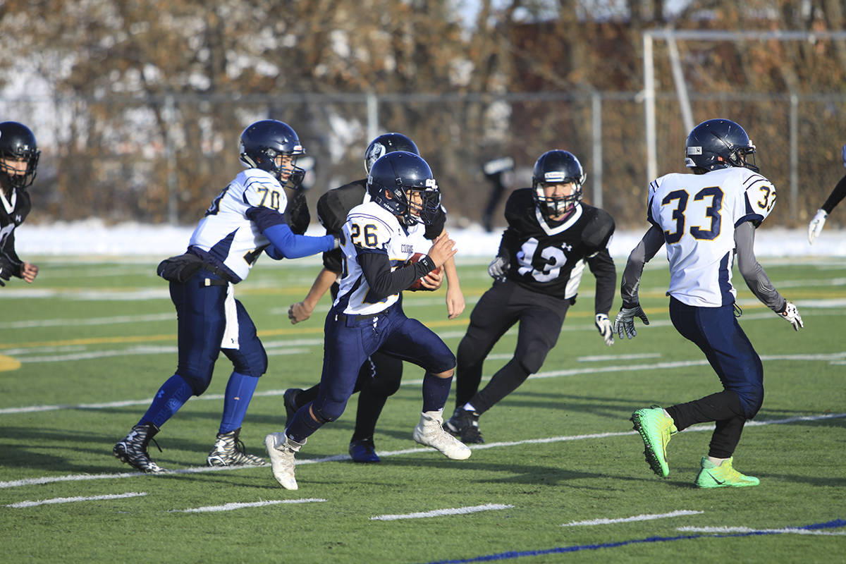 BANTAM CHAMPIONSHIPS - The Notre Dame Bantam Cougars and the Parkside Pythons squared off in the Alberta Provincial Tier II football championships. Cougar Audrin Uy broke through the line on this play on a drive that would eventually result in a score. Todd Colin Vaughan/Red Deer Express