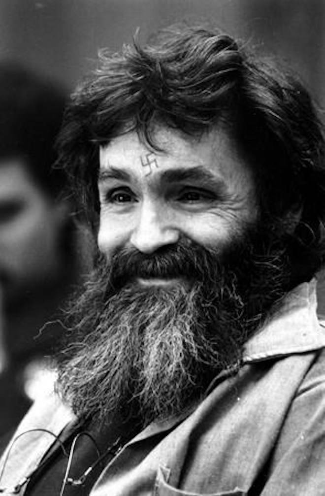 FILE - In this Feb. 4, 1986, file photo, convicted murderer Charles Manson looks towards the parole board in San Quentin, Calif. (AP Photo/Eric Risberg, File)