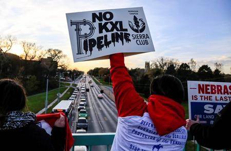 Opponents of the Keystone XL pipeline demonstrate on the Dodge Street pedestrian bridge during rush hour in Omaha, Neb., on Nov. 1, 2017. THE CANADIAN PRESS/AP, Nati Harnik