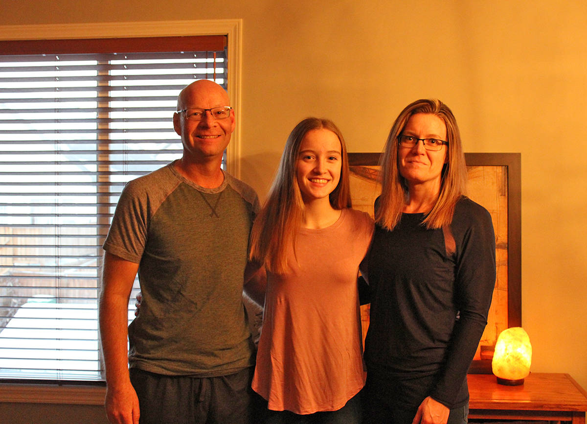 INSPIRING FAMILY - Abigail McQuay stands with her parents Bruce and Carla in their Red Deer home.Carlie Connolly/Red Deer Express