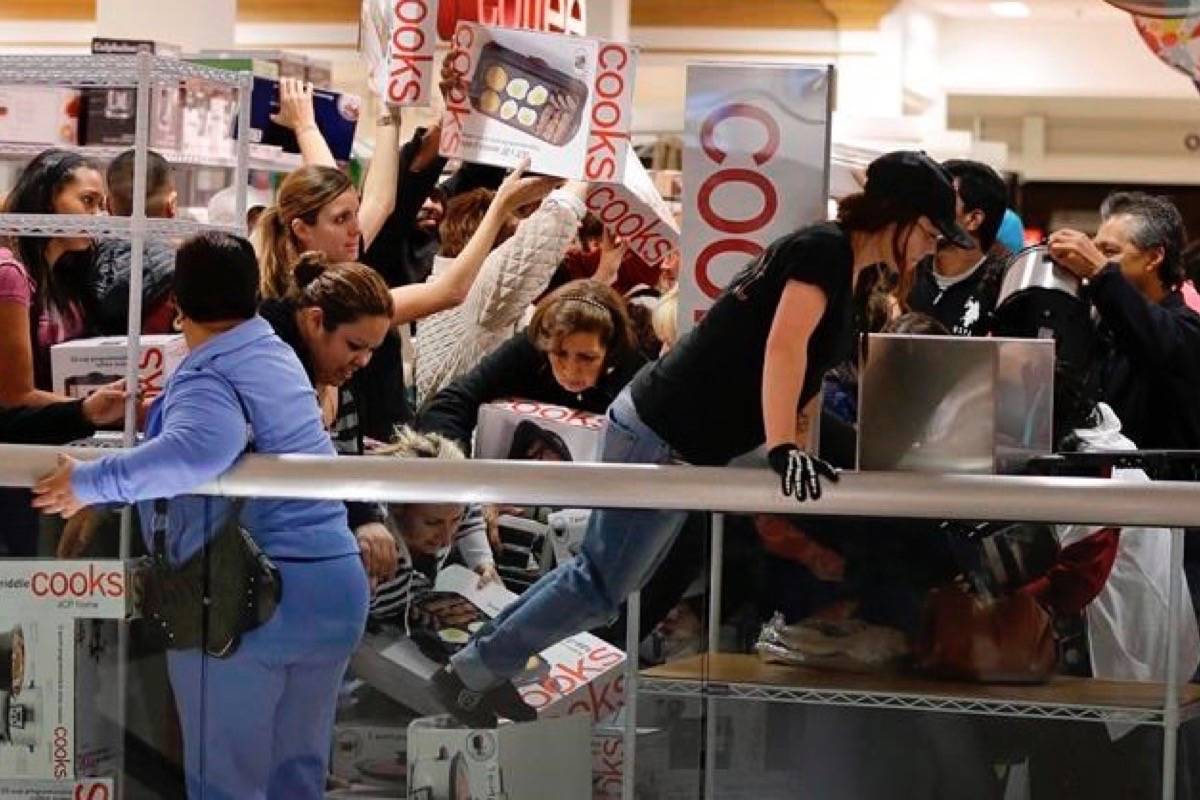 Shoppers rush to grab electric griddles and slow cookers on sale for $8 shortly after the doors opened at a J.C. Penney story in this file photo from Las Vegas on November 23, 2012. (Julie Jacobson/The Canadian Press/AP)Jacobson