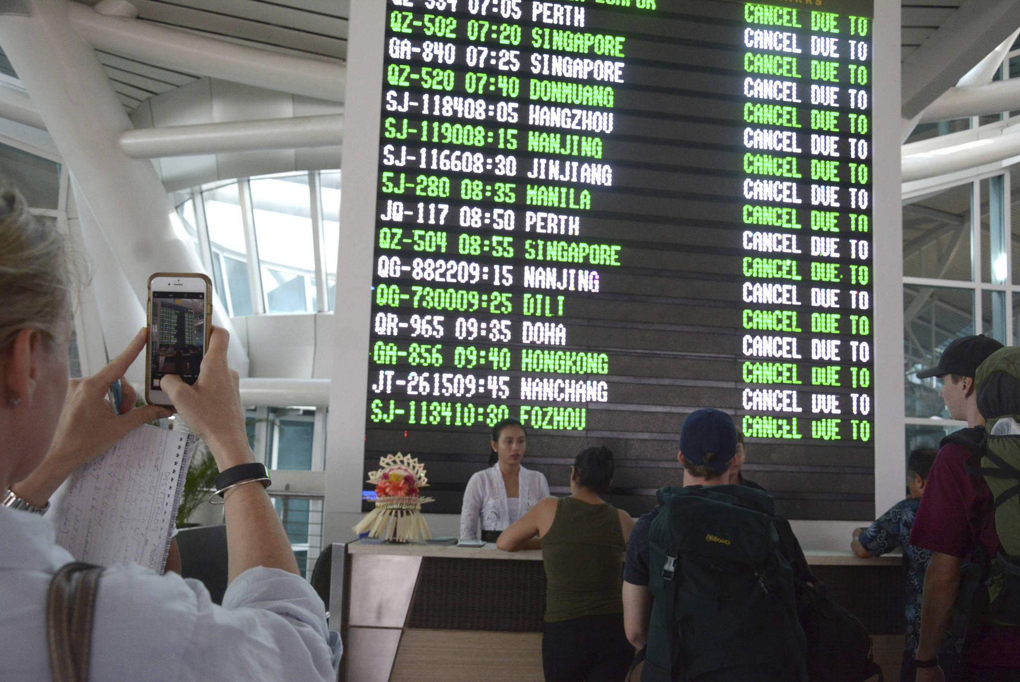 A flight information board shows cancelled flights at Ngurah Rai International Airport in Bali, Indonesia, Tuesday, Nov. 28, 2017. Indonesia’s disaster mitigation agency says the airport on the tourist island of Bali is closed for a second day due to the threat from volcanic ash. (AP Photo/Ketut Nataan)