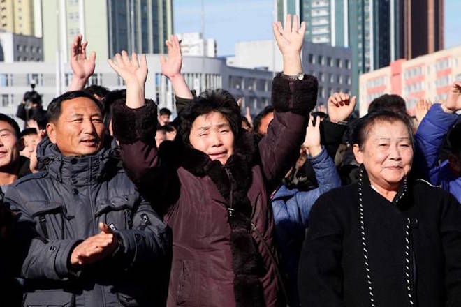 People cheer as they watch the news broadcast announcing North Korean leader Kim Jong Un’s order to test-fire the newly developed inter-continental ballistic missile Hwasong-15, Wednesday, Nov. 29, 2017, at the Pyongyang Train Station in Pyongyang, North Korea. (AP Photo/Jon Chol Jin)