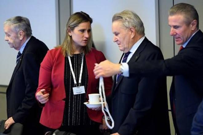 International Olympic Committee (IOC) members Denis Oswald, center right, of Switzerland, speaks with Angela Ruggiero, center left, from the United States, next to Gian-Franco Kasper, left, from Switzerland and Sergey Bubka, right, from the Ukraine, prior to the opening of the first day of the executive board meeting of the International Olympic Committee (IOC) at the IOC headquarters, in Pully near Lausanne, on Tuesday, Dec. 5, 2017. (Laurent Gillieron/pool photo via AP)